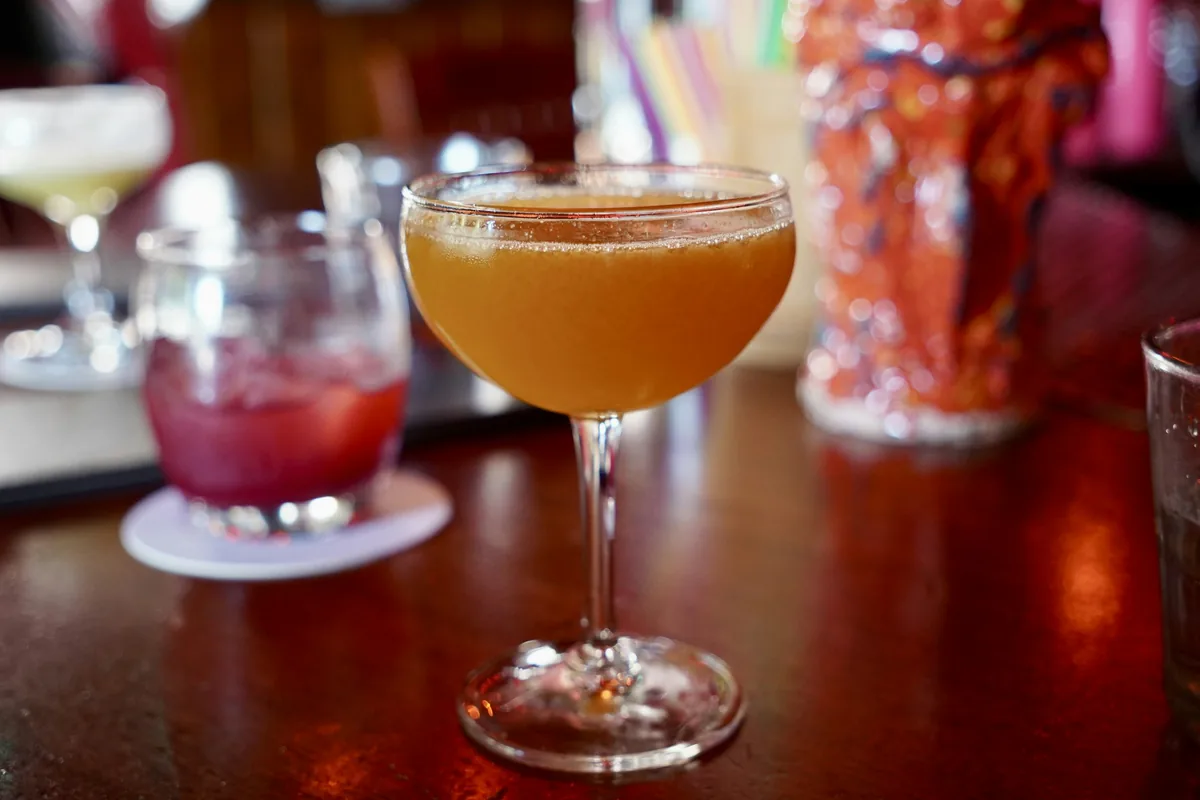 Sample photo: a cocktail in a coupe glass in warm bar light