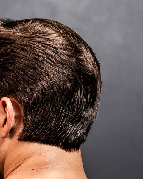 Back of a head with a slicked-back cut, long on top and tidy at the sides (example photo)