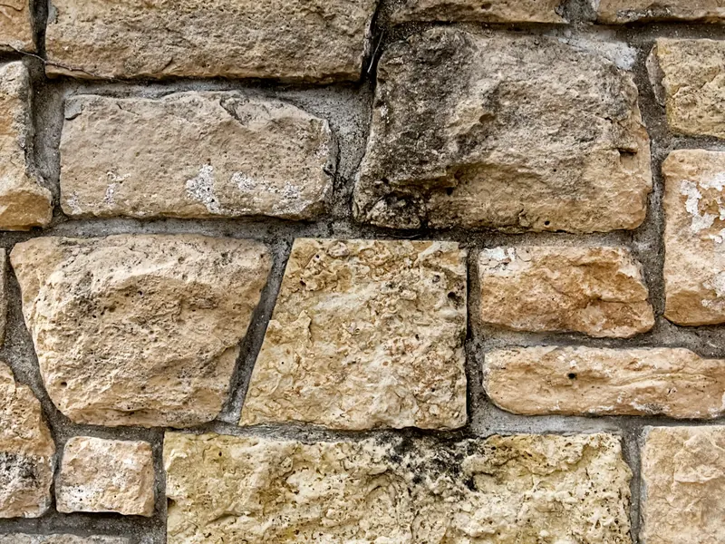 A natural stone wall with neatly pointed mortar joints.