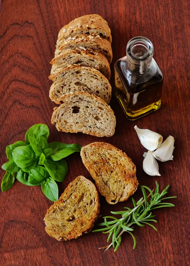 Sample photo: bread, olive oil, garlic and herbs on a board